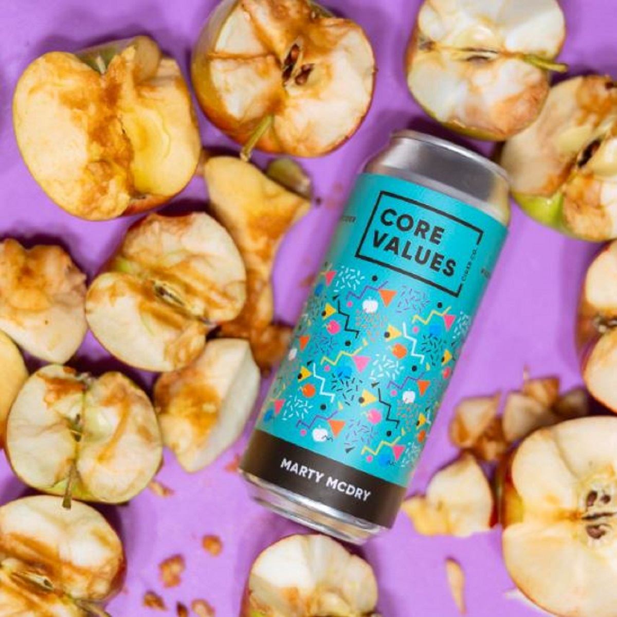 Marty cider surrounded by apples.