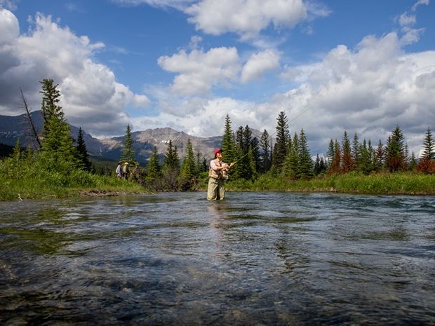 Women fly fishing in the river.