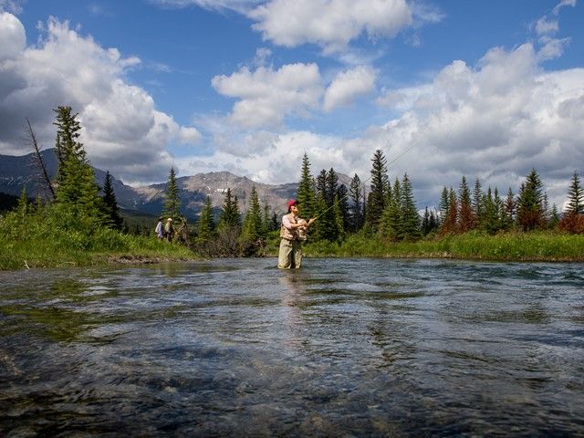 Women fly fishing in the river.