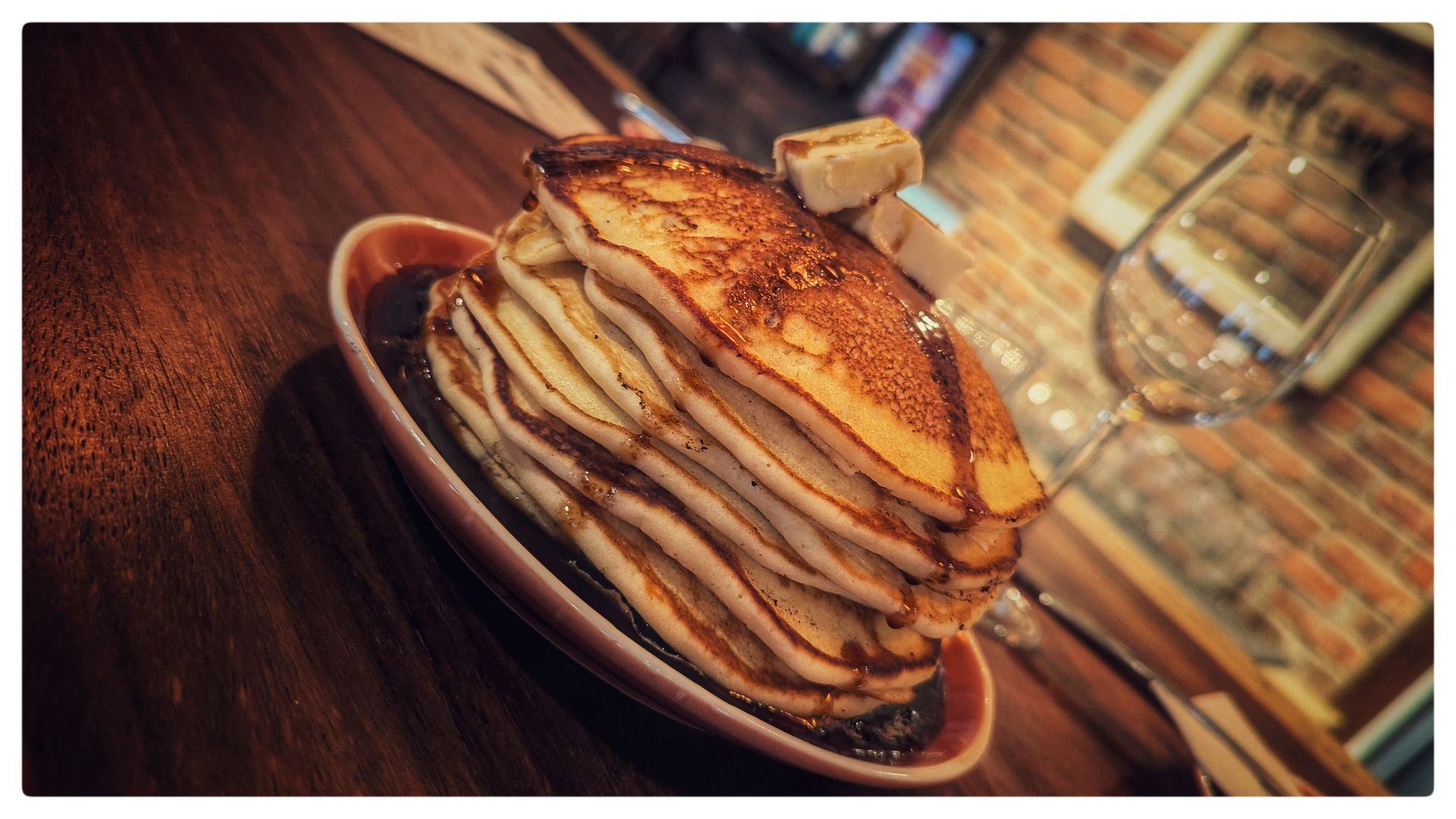 A large portion of pancakes with syrup.