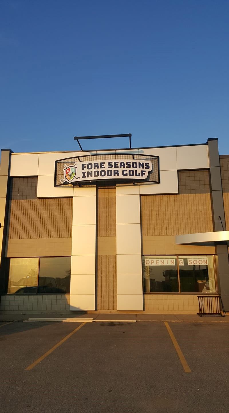 The exterior of Fore Seasons Indoor Golf Centre with its sign above the entrance.