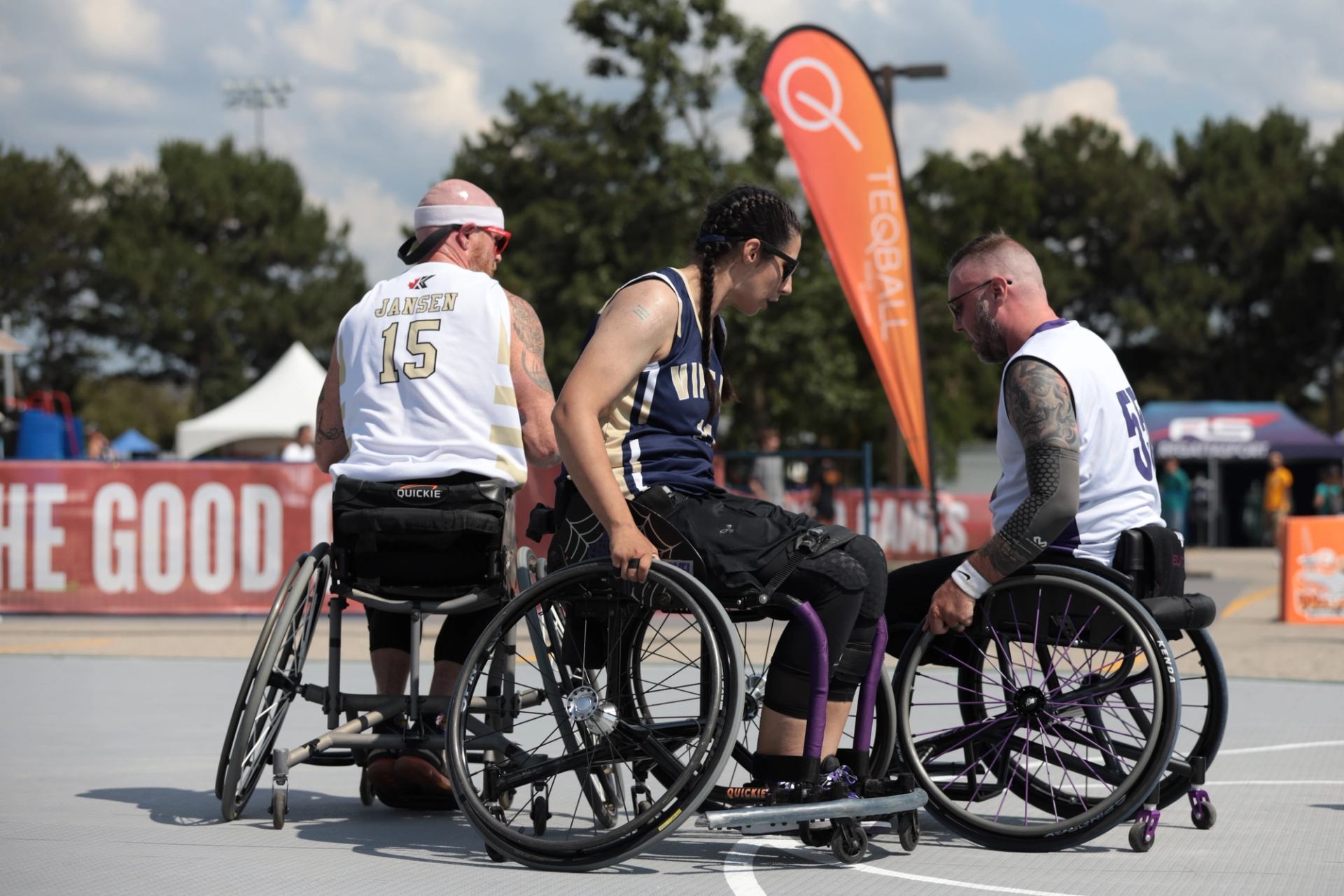 Athletes in wheelchairs play on outdoor court at The Good Games.
