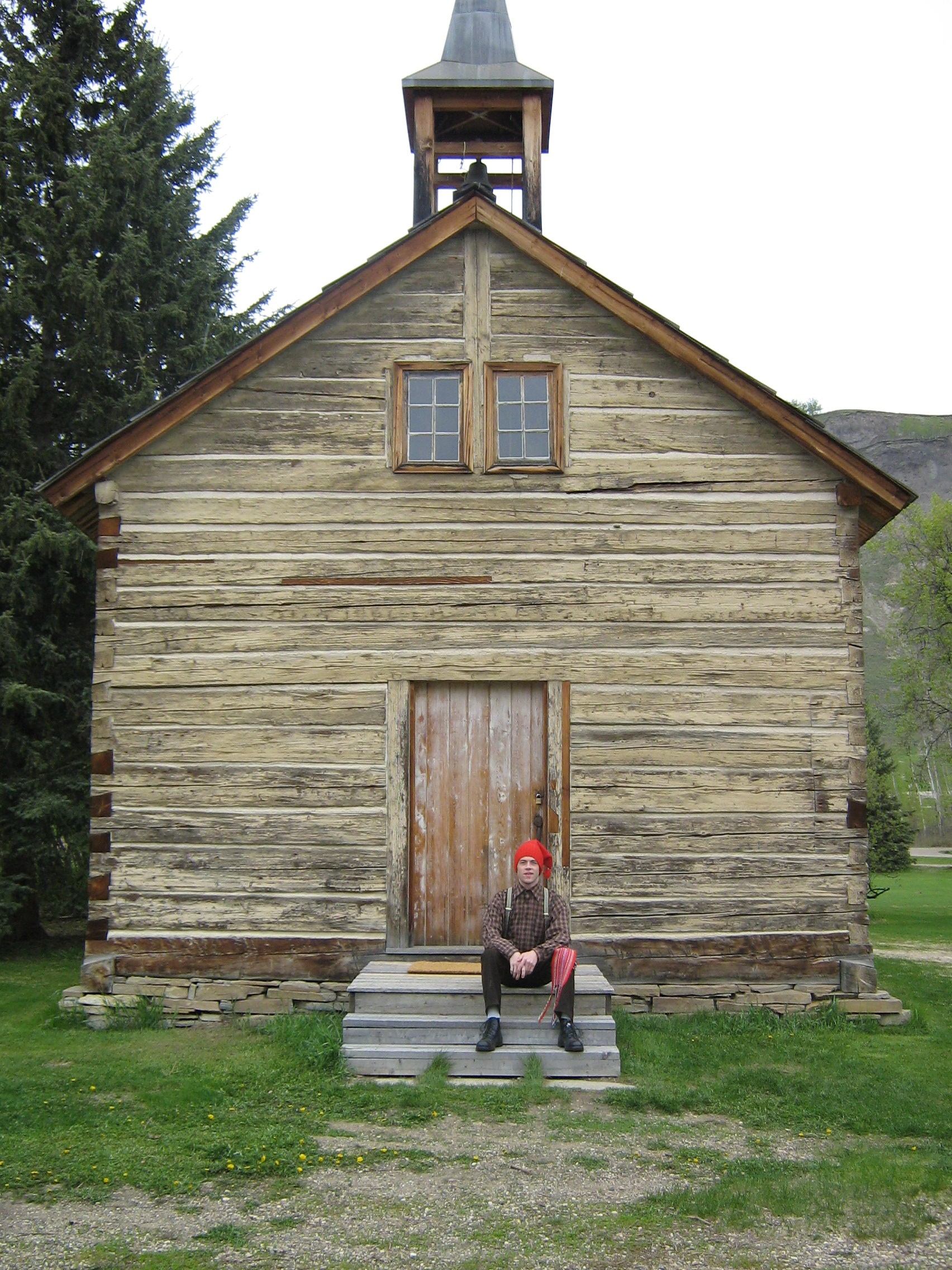 A man sat on the step at the chruch at The Historic Dunvegan