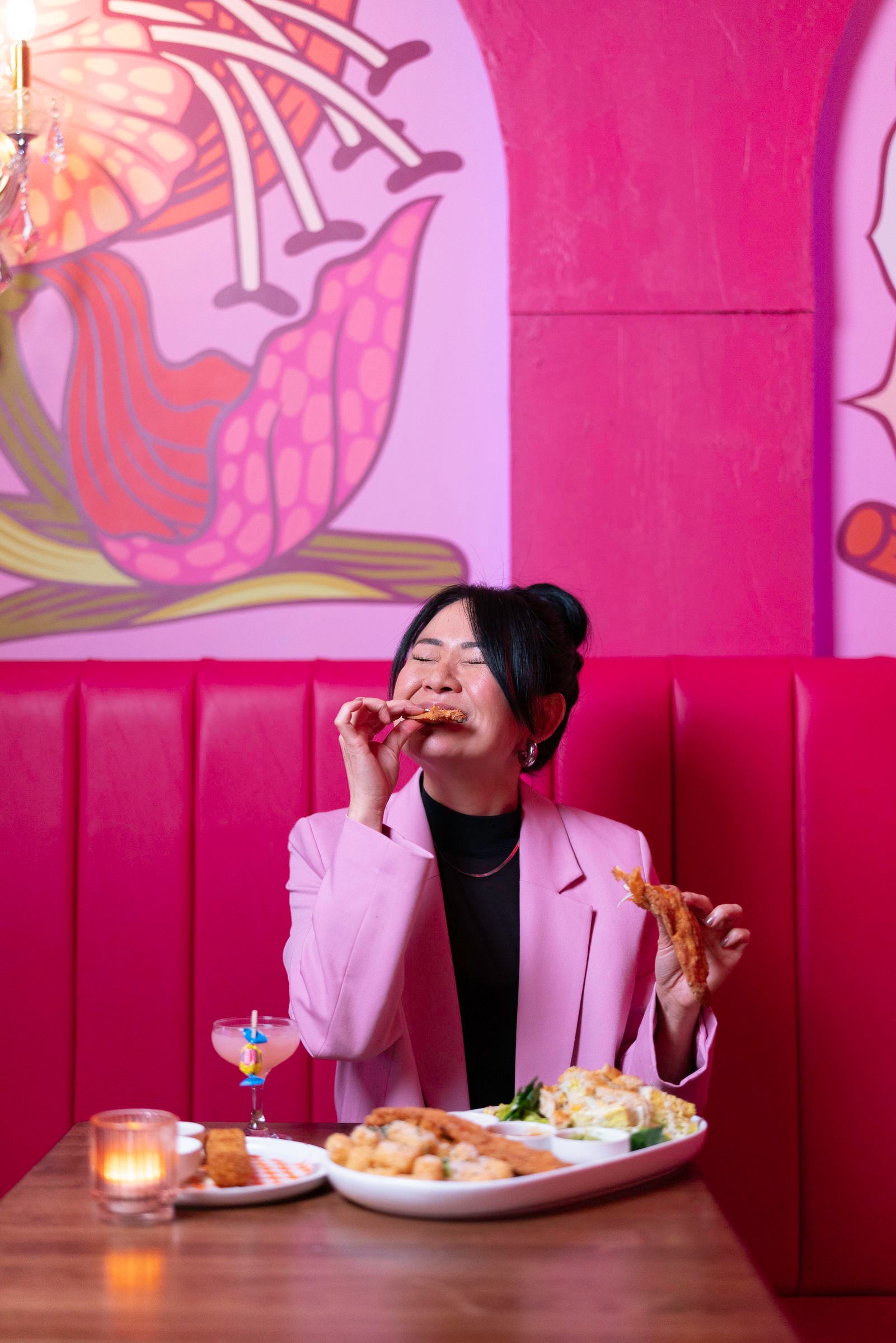 Woman enjoying food at Dolly's Cocktail Bar