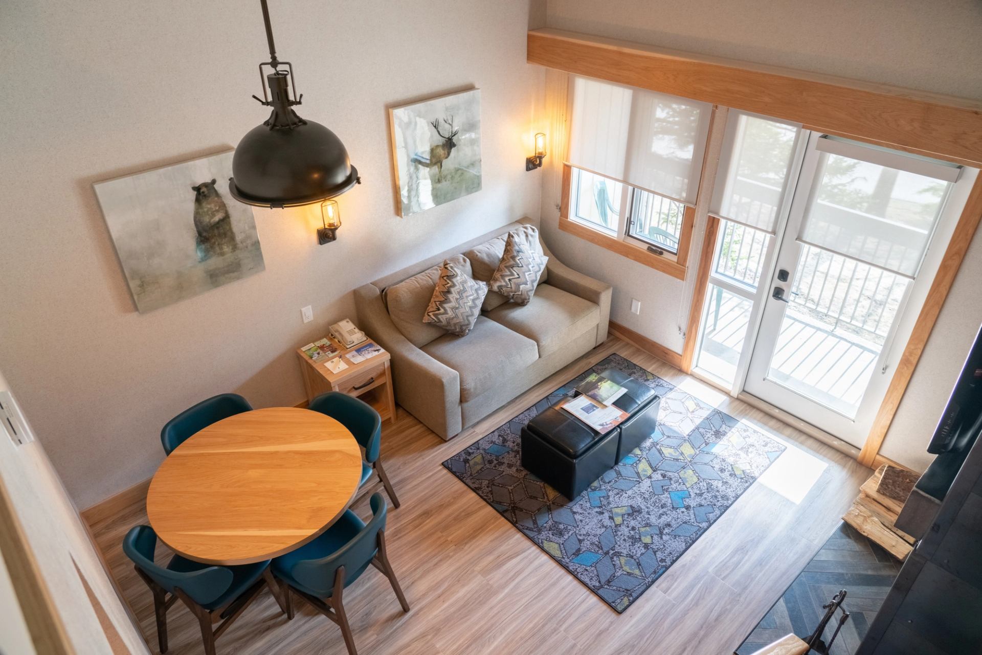 Cozy one bedroom foft condo with sofa, dining table, and natural light from patio doors.