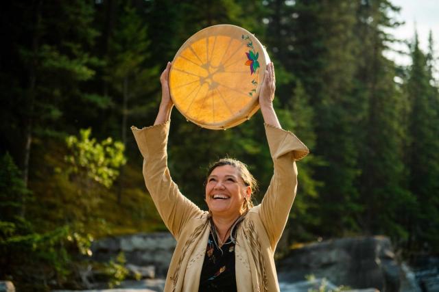 Women holding drum over head at Warrior Women.