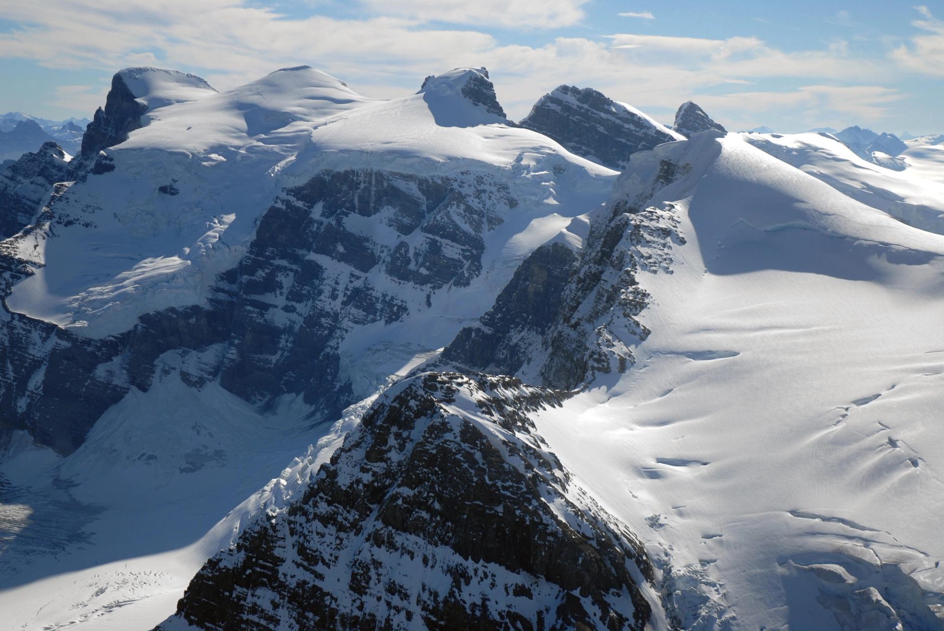 Aerial view of rugged snow covered mountain peaks in the Canadian Rockies.