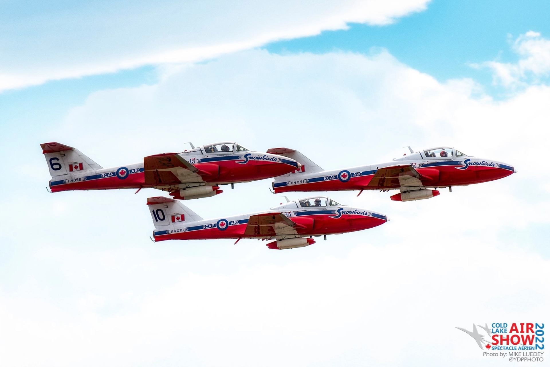 Three Canadair CT-114 Tutor jets, flown by the Canadian Forces Snowbirds aerobatic team.