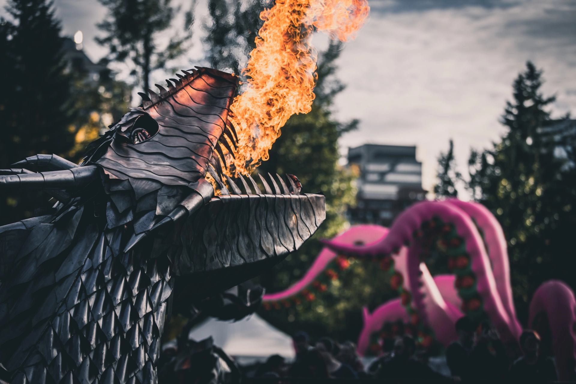 Fire exists the mouth of a dragon sculpture.