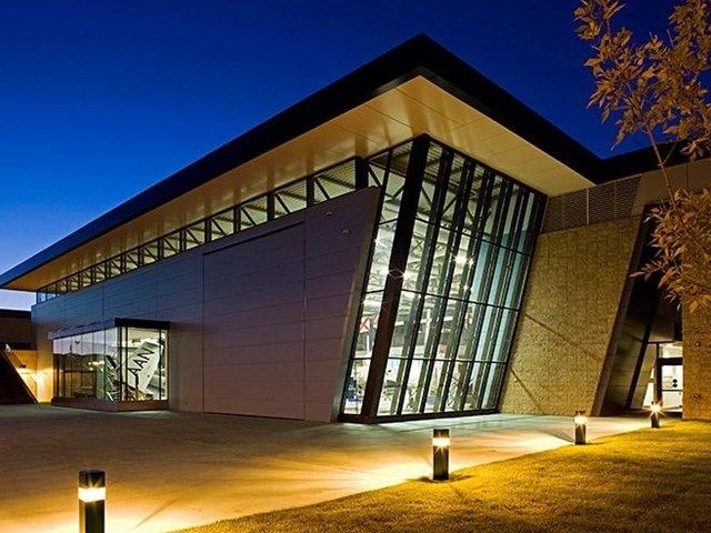 The exterior of a building at The Military Museums at night.