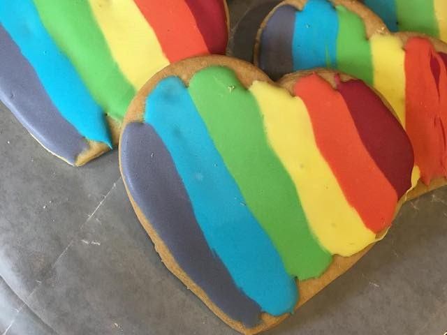 Heart-shaped cookie with vibrant rainbow icing
