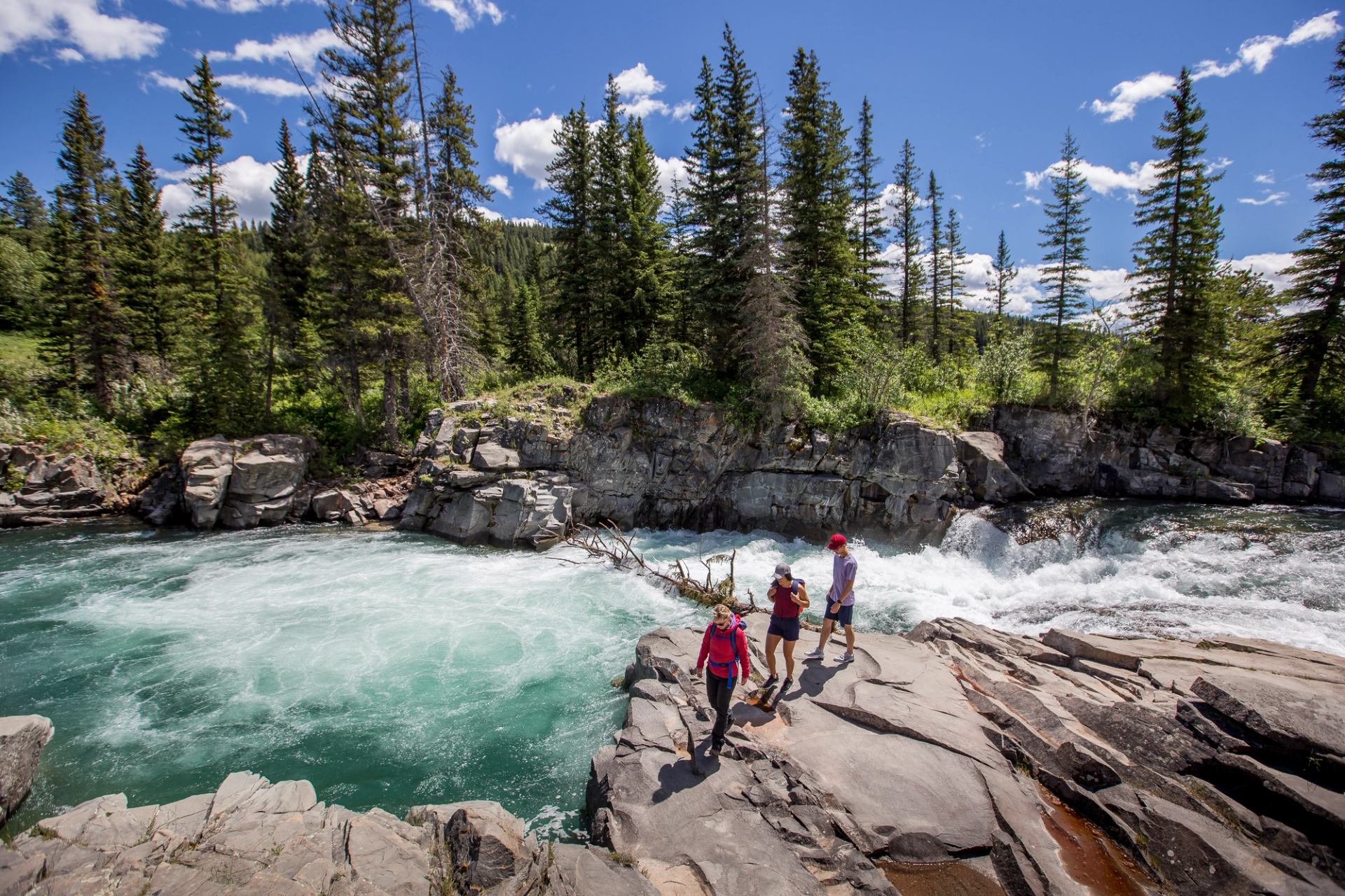 Three people hiking along Castle Falls