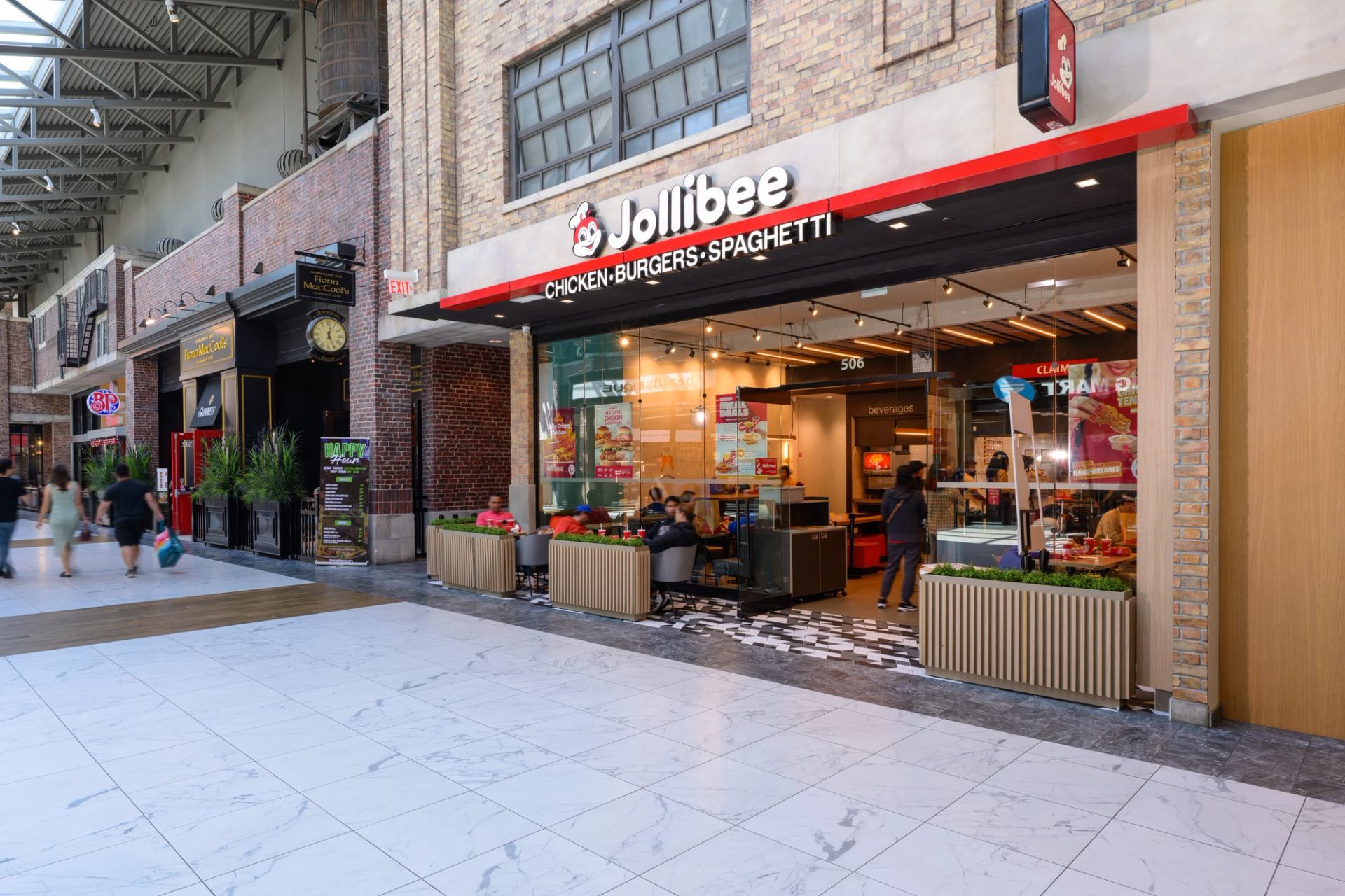 Jollibee storefront at CrossIron Mills with bright signage and busy mall entrance.
