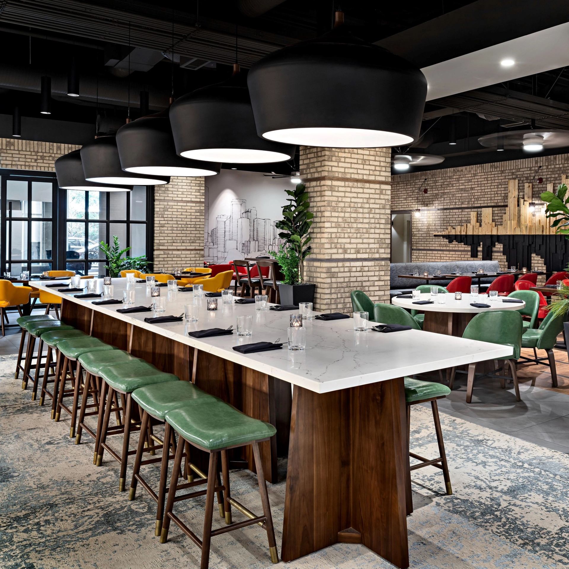Interior of Flower & Wolf Calgary with bar stools and brick walls.