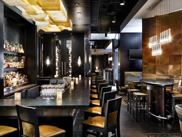 Elegant hotel bar with modern lighting and stylish seating.