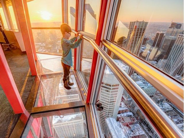 Boy standing on the glass floor of the Calgary Tower.