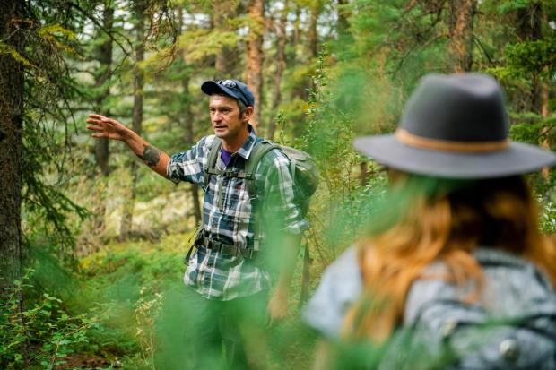 Mahikan Trails guide telling visitors about the forrest on a guided tour.