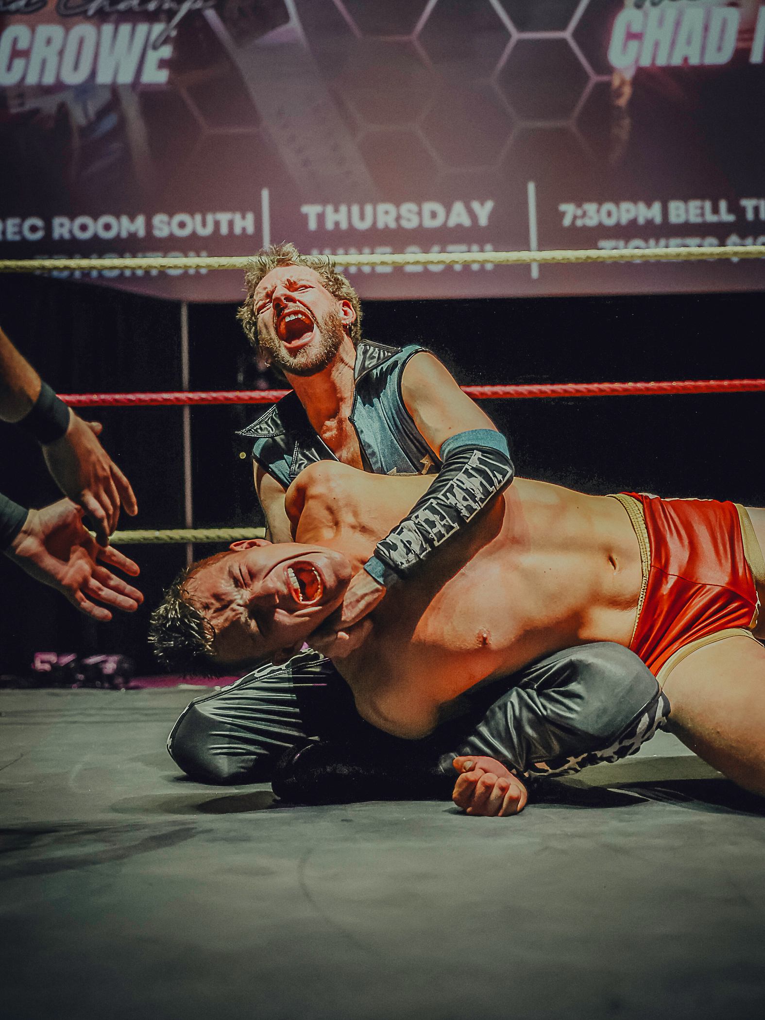 One wrestler applies a hold to another on the mat during a Love Pro Wrestling match.