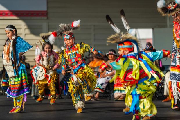 Indigenous child dancers performing at Elbow River camp at the Calgary Stampede.