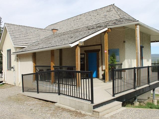 Exterior of Northern Rockies Museum with ramp and rustic architecture.