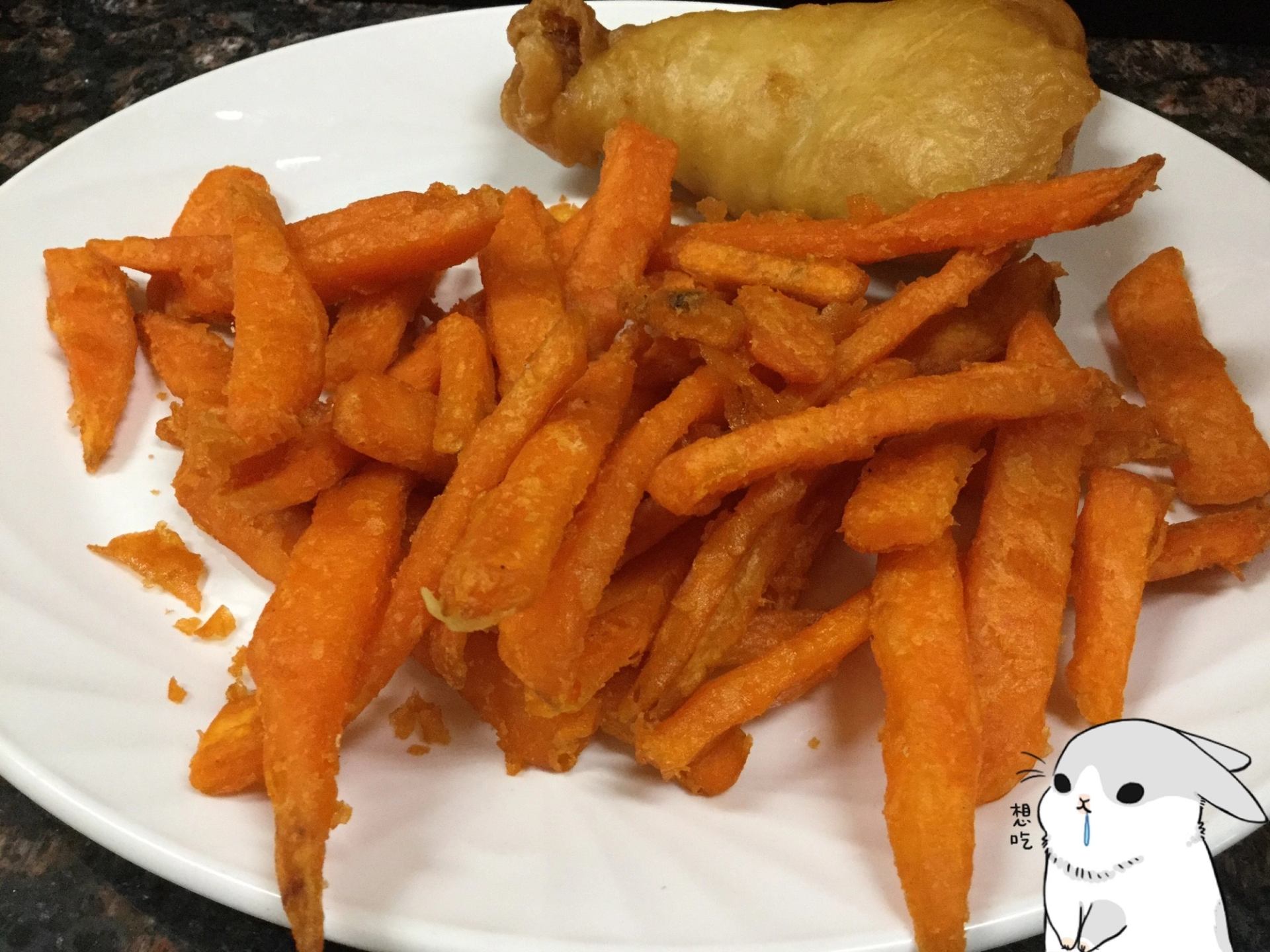 Plate with sweet potato fries and fried chicken.