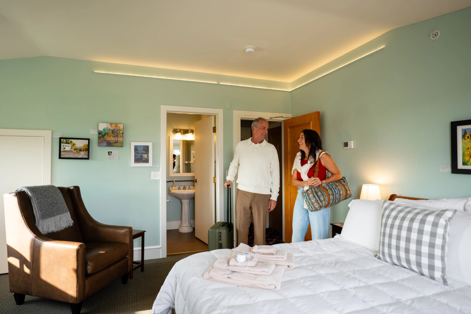 A couple arriving at their room in Rosebud Country Inn.