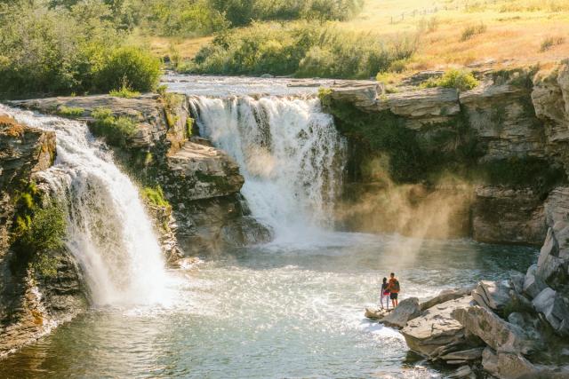 Couple sightseeing and enjoying the view at Lundbreck Falls.