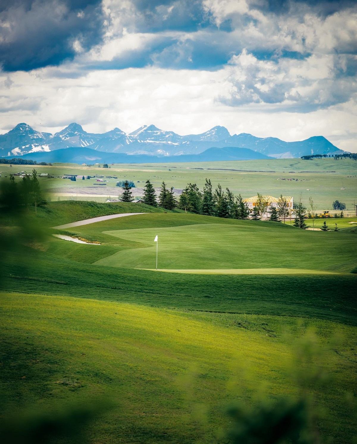 Lush fairway at Mickelson National Golf Club with mountain views in the distance.
