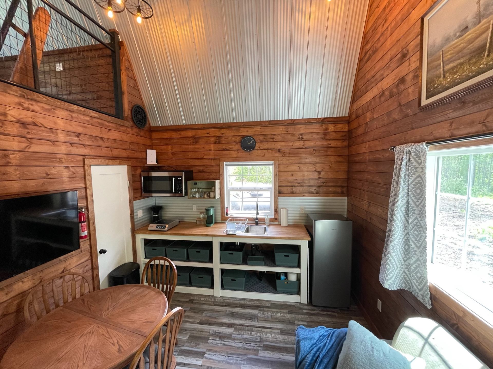 Rustic cabin kitchen and lounge area at Wildly Eweneek Cabins.