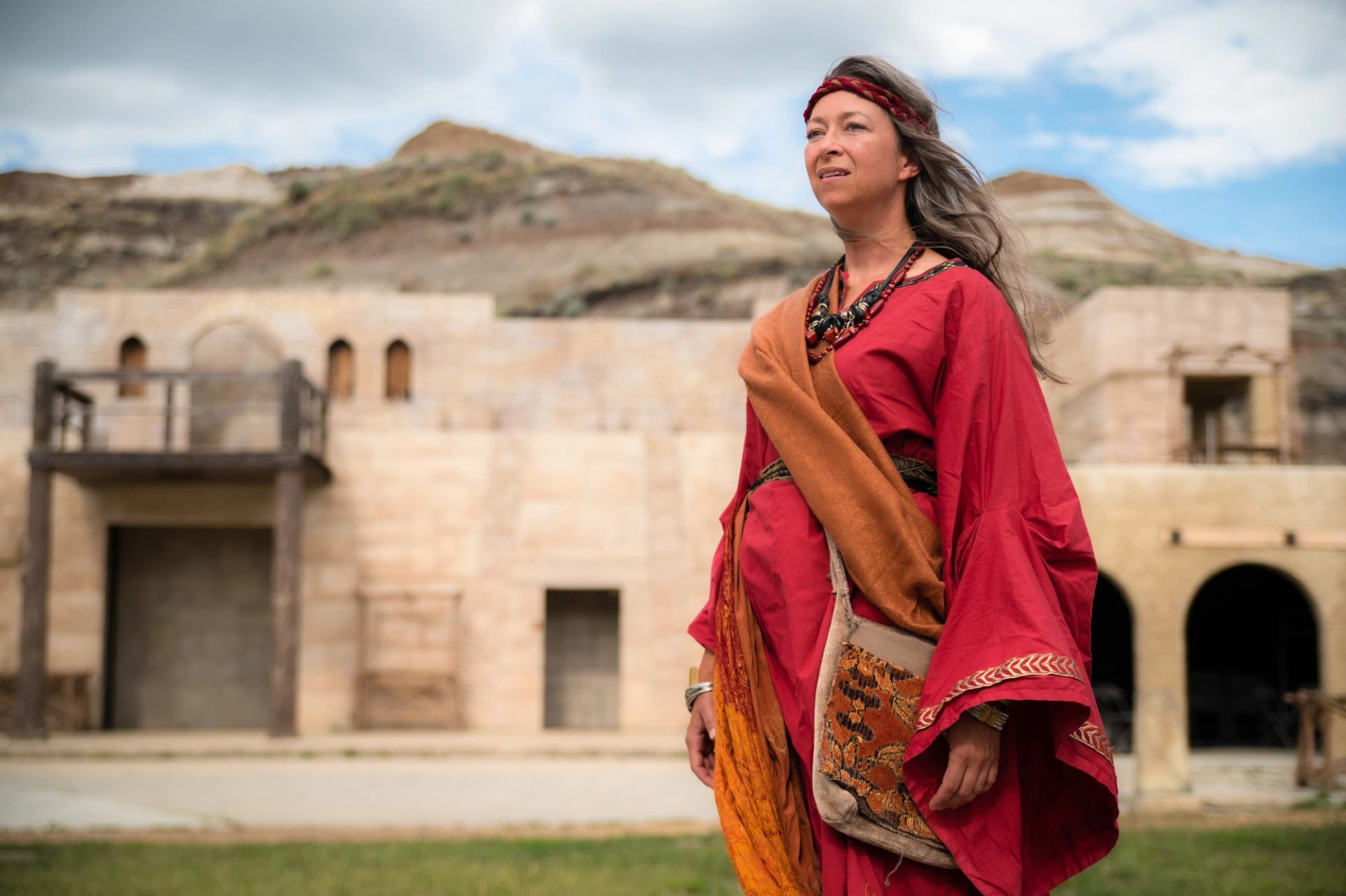 Mary Magdalen actor in red costume on stage at the Badlands Passion Play/Badlands Amphitheatre