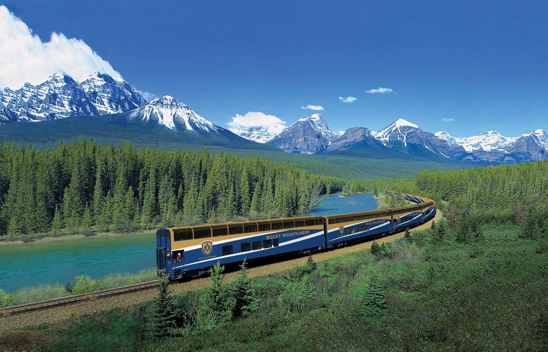 Rocky Mountaineer traveling through lush alpine landscape.