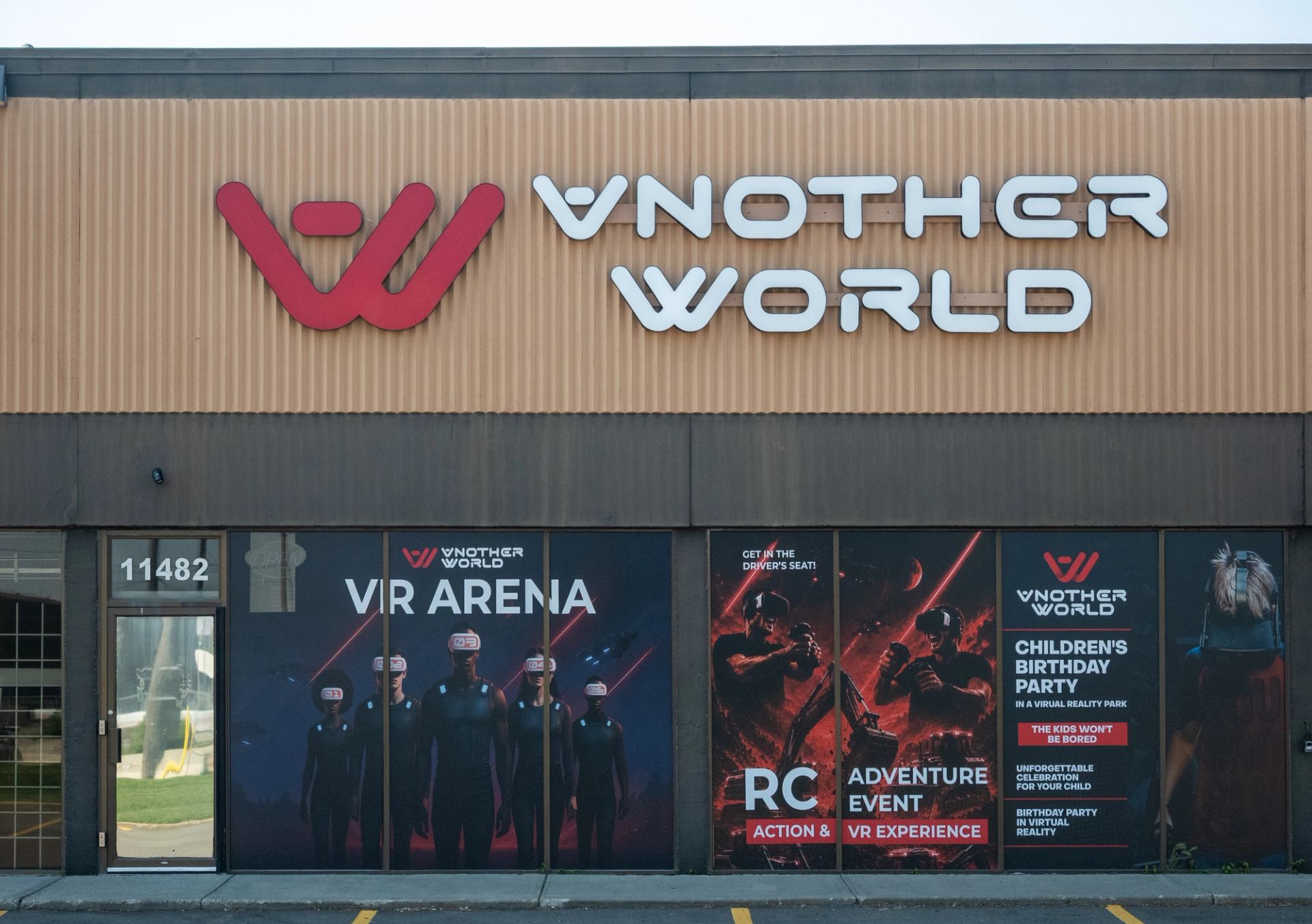 Vnother World VR arena storefront with large signage and virtual reality window graphics.
