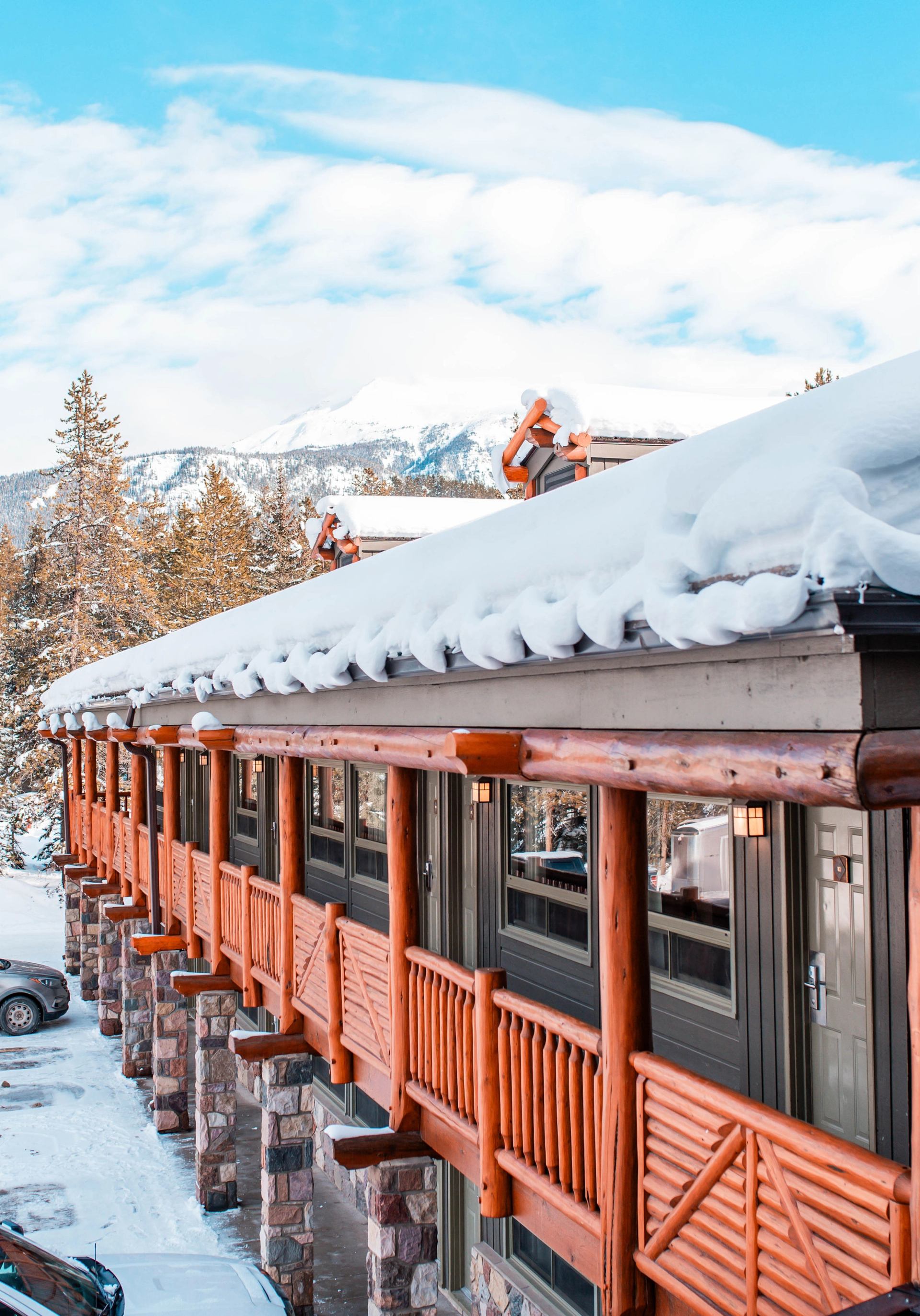 Snow-covered hotel roof in beautiful Lake Lake Louise surrounded by mountains - a scenic winter sigh