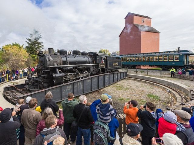 Steam train 1225 on turntable with crowd at Heritage Park.