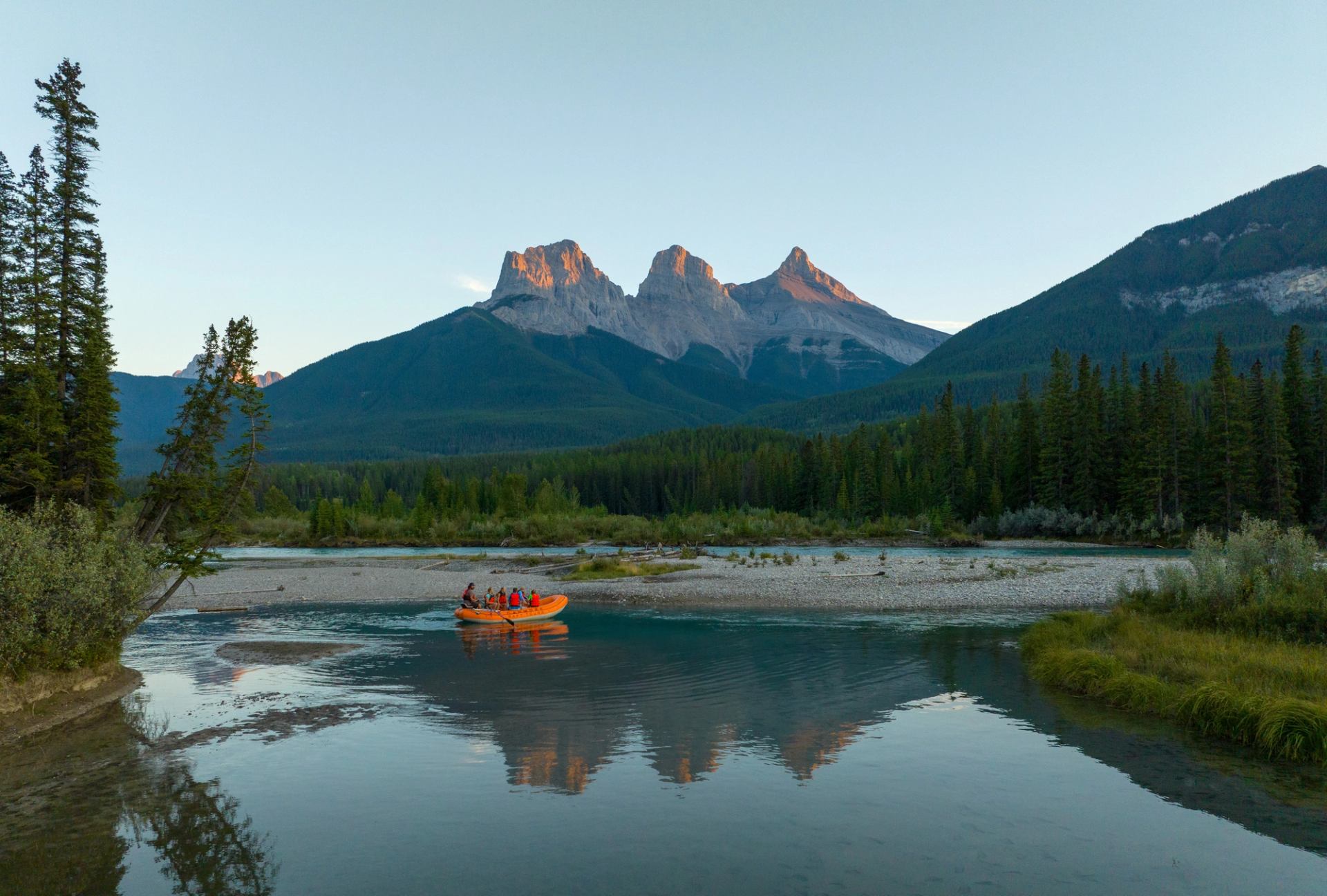 Canmore Raft Tours take their participants to get a view of the Three Sisters as the sun sets and the light fades from the mountains.