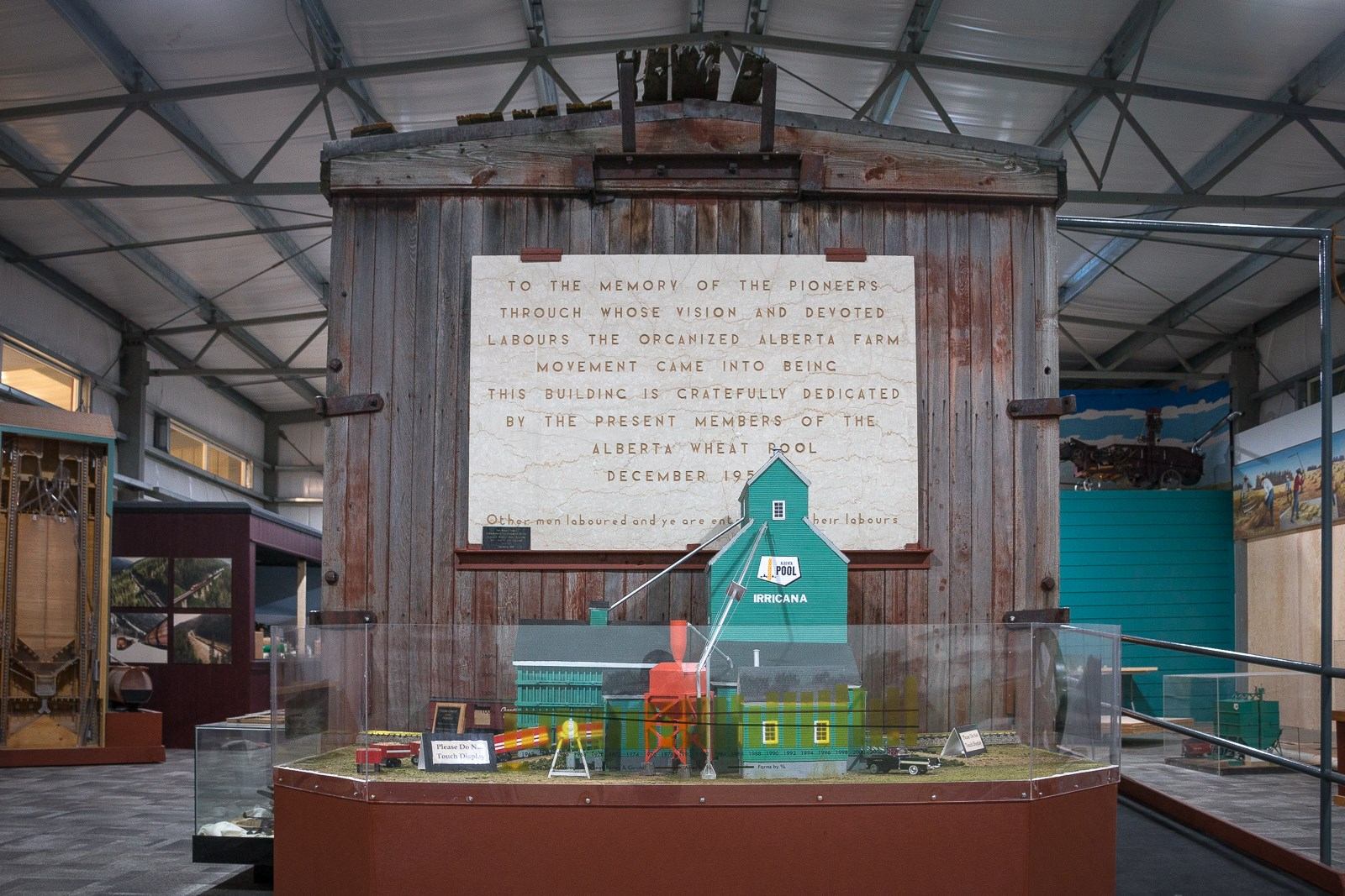 A photo of a model grain elevator set up against the front of an old boxcar
