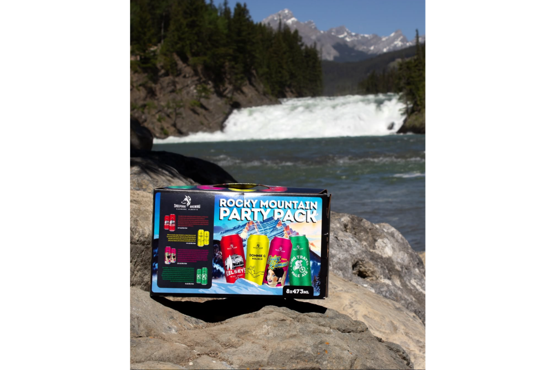Rocky Mountain Party Pack box on rocks beside rapids and snow-capped mountains.
