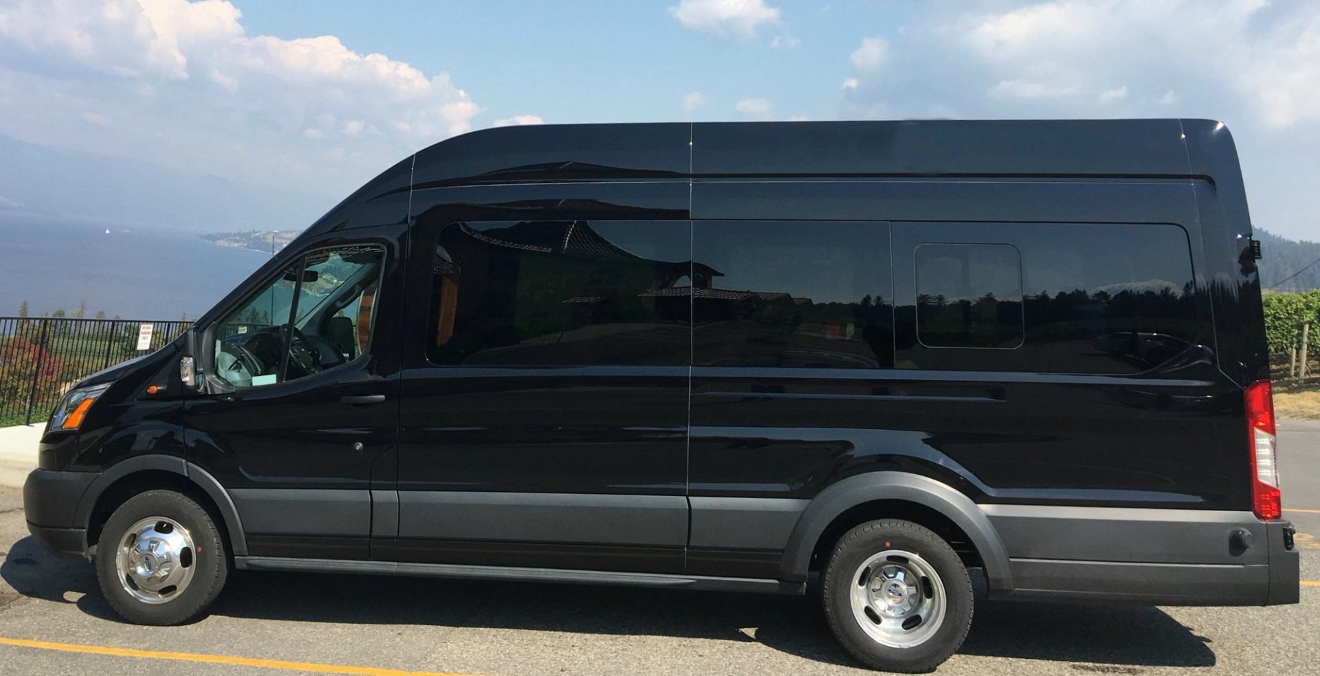 Black 14 passenger shuttle van for tours and vacations