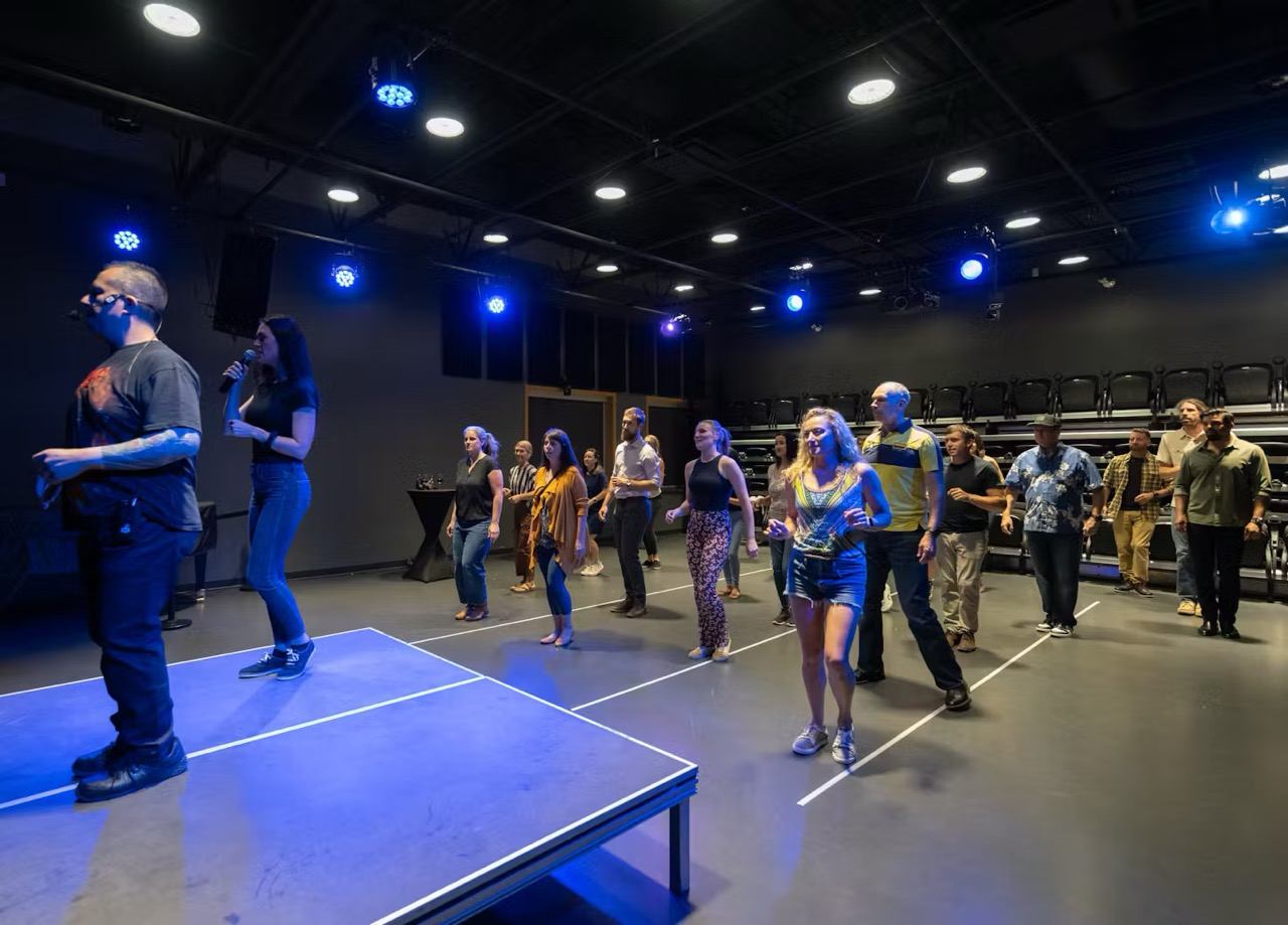 A group of people taking Latin Dance lessons.