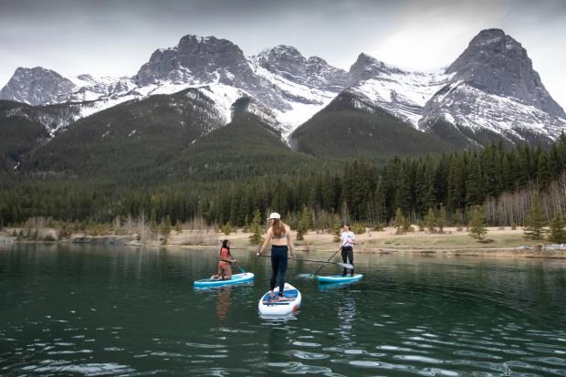 People paddle boarding on Quarry Lake in Canmore.