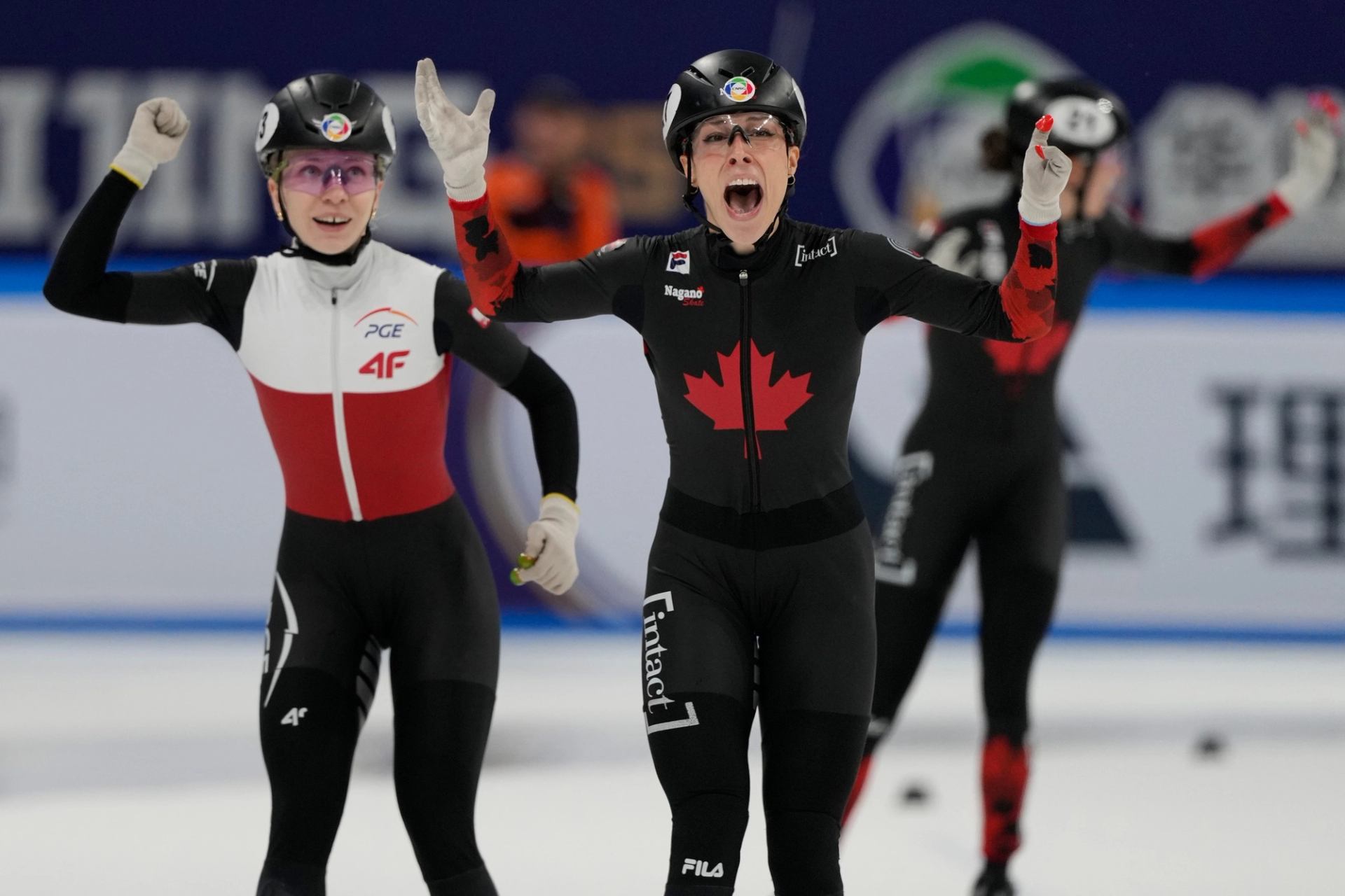 Speed skaters from Canada and Poland racing at the ISU World Cup on an indoor rink.