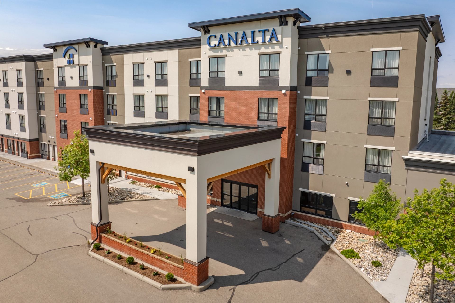 Canalta hotel exterior with covered entrance, parking area and small landscaped garden beds.