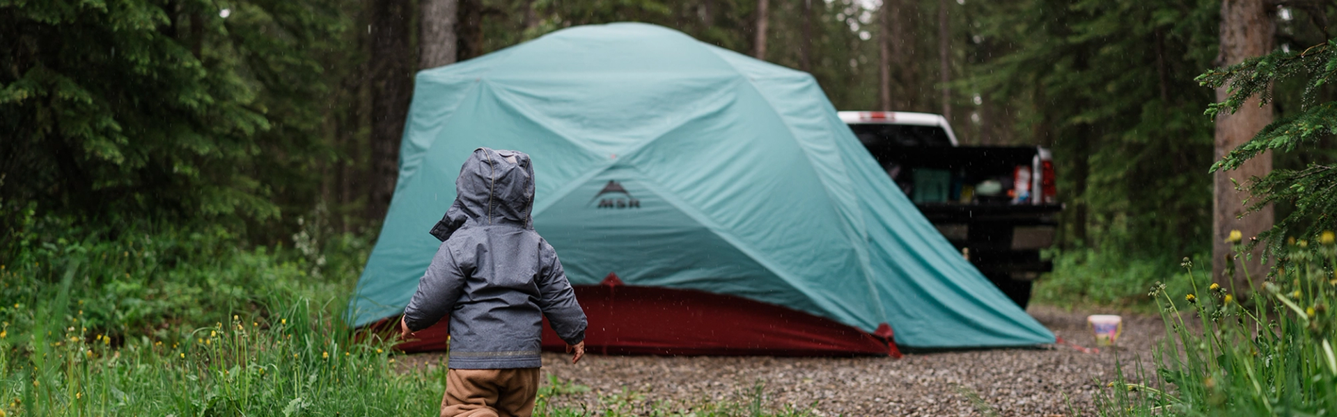 Forest campground with creek running through sites at Burnt Timber Provincial