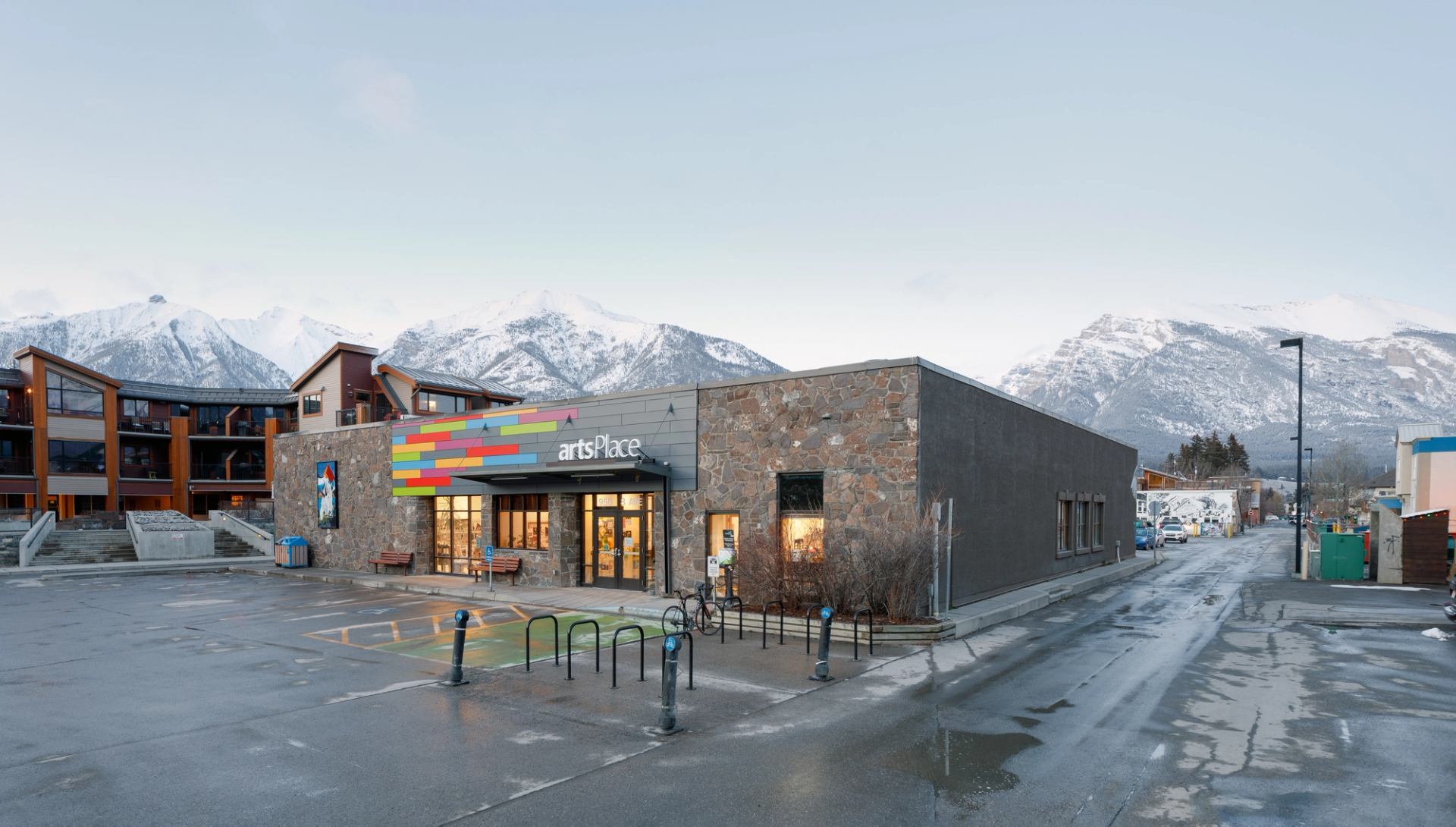 The artsPlace building sits in downtown Canmore, surrounded by mountains.