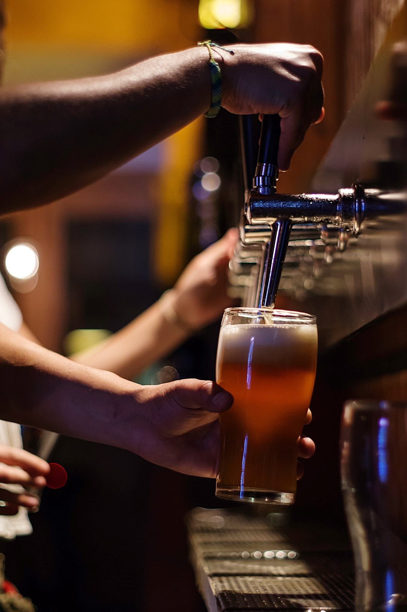 Close-up of beer being poured from tap into glass at Common Crown Brewing Co.