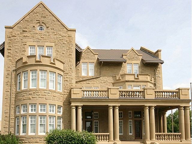 Government House Alberta historic stone building with columns and arched windows, Edmonton.