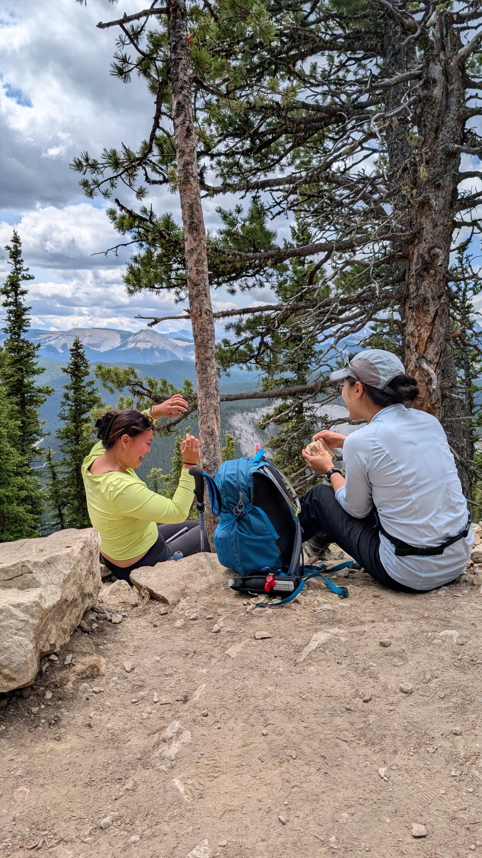 Two people sat having a rest on their hike.