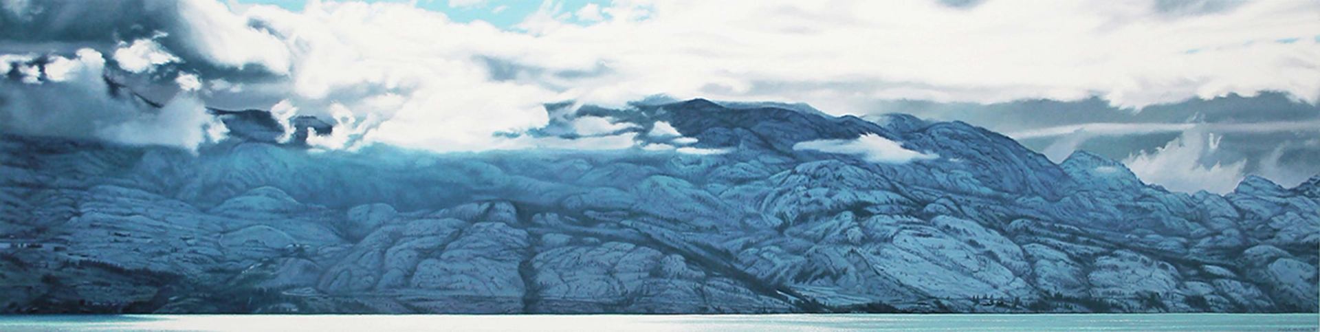 Snow-covered mountain range rises beyond calm water beneath low clouds.