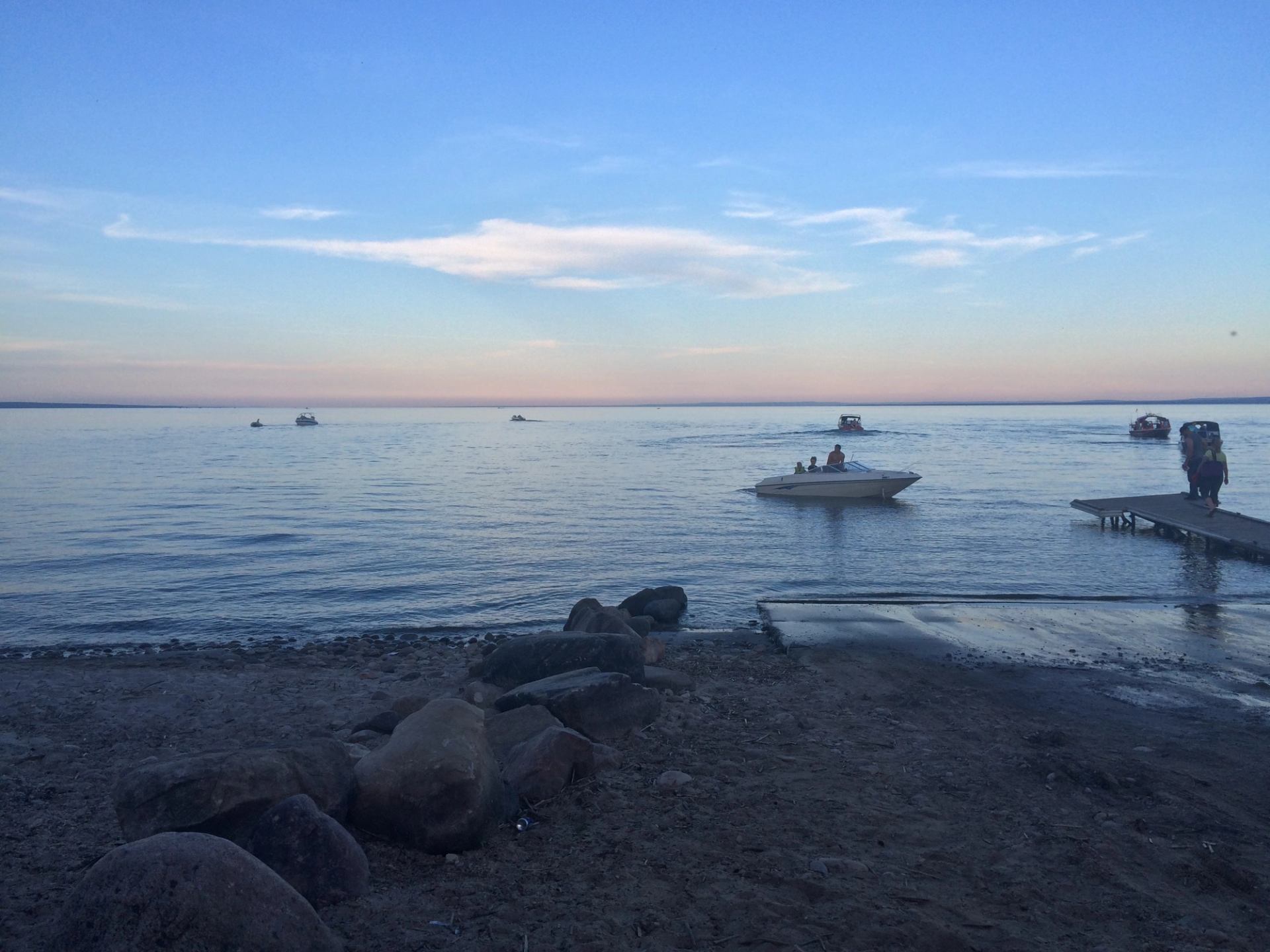 Boats coming in to the boat launch in the evening.