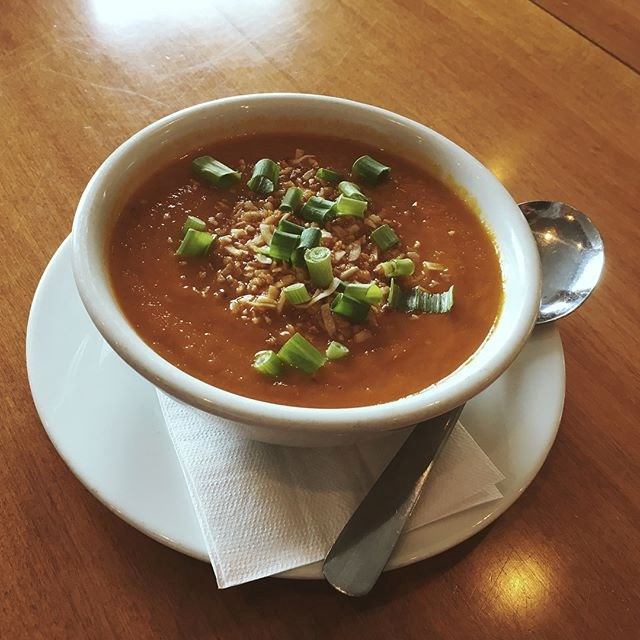 Bowl of tomato soup topped with green onions at Waters Edge Pub & Café.